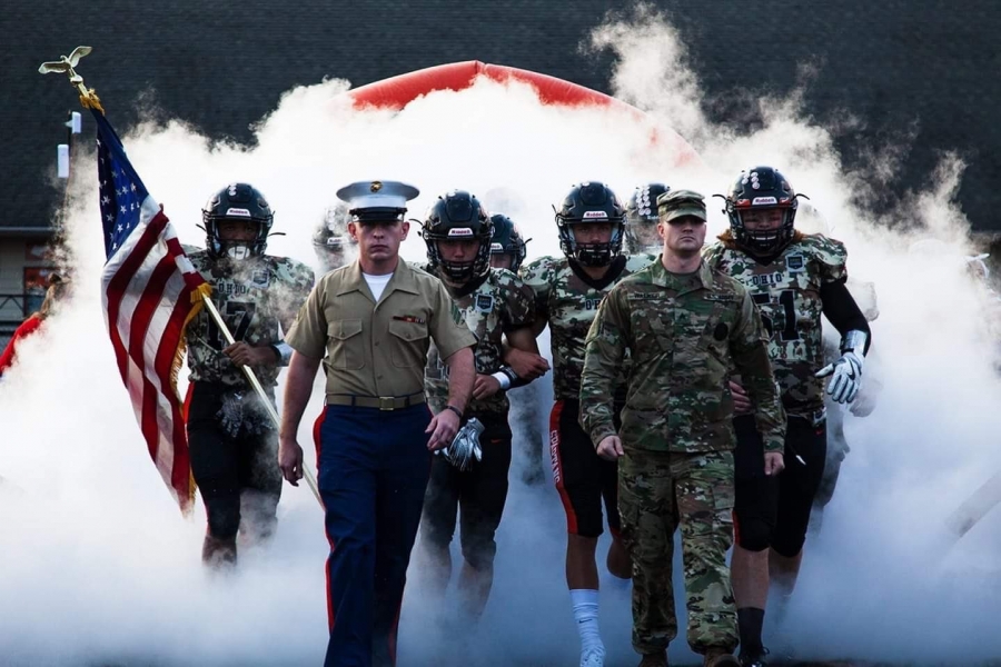 military and football people with smoke